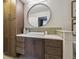 Modern bathroom featuring a vessel sink, decorative backsplash, and ample cabinet space at 2449 Xanthia St, Denver, CO 80238