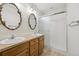 Bathroom with a glass door shower, and double sink with matching ornate mirrors at 2449 Xanthia St, Denver, CO 80238