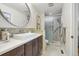 Stylish bathroom features a modern vanity with a sleek sink and a glass-enclosed shower at 2449 Xanthia St, Denver, CO 80238