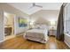 Comfortable bedroom featuring hardwood floors, a ceiling fan, and large windows at 2449 Xanthia St, Denver, CO 80238