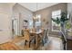 Spacious dining room with high ceilings, a chandelier, and large windows for ample natural light at 2449 Xanthia St, Denver, CO 80238