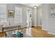 Bright living room with hardwood floors, neutral walls, and an inviting view of the front entrance at 2449 Xanthia St, Denver, CO 80238