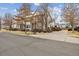 Street view of a multi-story home with red brick and white siding at 2449 Xanthia St, Denver, CO 80238