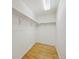 Simple walk-in closet featuring hardwood floor and shelving at 2449 Xanthia St, Denver, CO 80238