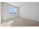 Bright bedroom with carpeted floors and large window at 457 Interlocken Blvd # 102, Broomfield, CO 80021