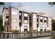 Modern three-story townhomes with brick and light-colored siding, showcasing a sleek design at 457 Interlocken Blvd # 102, Broomfield, CO 80021