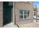 Brick exterior with gray front door and window at 457 Interlocken Blvd # 102, Broomfield, CO 80021