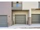 Attached garage with gray door at 457 Interlocken Blvd # 102, Broomfield, CO 80021