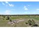 Expansive rural land featuring mature trees and a cozy fire pit area at 897 E Rim Rd, Franktown, CO 80116