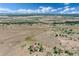 Sweeping aerial perspective of an estate amidst wide-open plains and patchy tree cover at 897 E Rim Rd, Franktown, CO 80116