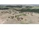 Aerial view of a single Gathering home with beautiful acreage, trees, and a pond in a serene countryside setting at 897 E Rim Rd, Franktown, CO 80116