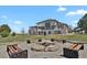 Spacious backyard features an outdoor sitting area with benches around a stone fire pit at 897 E Rim Rd, Franktown, CO 80116
