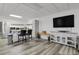 Finished basement offers an entertainment area with a large TV and a modern kitchenette at 897 E Rim Rd, Franktown, CO 80116