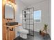 Bathroom featuring white subway tile, black shower with glass, floating vanity, and unique light fixtures at 897 E Rim Rd, Franktown, CO 80116