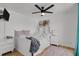 Well-lit bedroom features a ceiling fan, white furniture, hardwood floors and a cozy rug at 897 E Rim Rd, Franktown, CO 80116