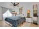 Bright bedroom with ceiling fan and decorative tapestry hanging over the bed at 897 E Rim Rd, Franktown, CO 80116