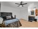 Bedroom featuring hardwood floors, a ceiling fan and access to a bathroom and closet at 897 E Rim Rd, Franktown, CO 80116
