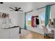 Cozy bedroom with bright curtains, a ceiling fan, and plenty of natural light from two windows at 897 E Rim Rd, Franktown, CO 80116