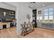 Bright entryway featuring stylish light fixture, wood flooring, and view to adjacent office/living room at 897 E Rim Rd, Franktown, CO 80116