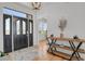 Bright entryway featuring stylish light fixture, white tile detail and view to adjacent office at 897 E Rim Rd, Franktown, CO 80116