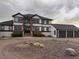 Two-story home featuring a three-car garage and attractive architectural details at 897 E Rim Rd, Franktown, CO 80116