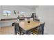 Bright kitchen with white cabinetry, stainless steel appliances, and a charming eat-in dining area at 897 E Rim Rd, Franktown, CO 80116