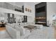 Bright living room featuring tall ceilings, modern fireplace and staircase to the loft at 897 E Rim Rd, Franktown, CO 80116
