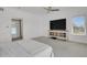 Spacious main bedroom with a ceiling fan, large windows, and stylish decor with a big screen tv at 897 E Rim Rd, Franktown, CO 80116
