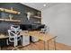 Modern office space with custom shelves, black accent wall, and wood desks at 897 E Rim Rd, Franktown, CO 80116