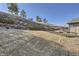 Spacious backyard with a tiered stone wall and lush green grass at 23960 E Easter Pl, Aurora, CO 80016