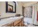 Well-lit bathroom featuring a vanity with storage and a shower-tub combo with neutral tiling at 23960 E Easter Pl, Aurora, CO 80016