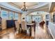 Open-concept dining area showcasing hardwood floors, elegant decor, and abundant natural light at 23960 E Easter Pl, Aurora, CO 80016