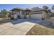 Inviting home showcasing a stone-accented facade, covered porch, and a spacious driveway at 23960 E Easter Pl, Aurora, CO 80016
