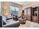 Elegant living room with comfortable seating, a stylish coffee table, and a built-in display cabinet at 23960 E Easter Pl, Aurora, CO 80016