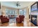 Elegant living room boasting hardwood floors, a fireplace, and ample natural light at 23960 E Easter Pl, Aurora, CO 80016