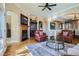 Spacious living room featuring hardwood floors, a fireplace, and stylish furnishings at 23960 E Easter Pl, Aurora, CO 80016