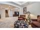 Cozy living room features plush seating, soft carpet, and a stylish archway to the staircase at 23960 E Easter Pl, Aurora, CO 80016