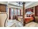 Luxurious main bedroom featuring a four-poster bed, elegant furnishings, and ample natural light at 23960 E Easter Pl, Aurora, CO 80016