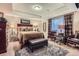 Serene main bedroom featuring a tray ceiling, soft textures, and luxurious furnishings at 23960 E Easter Pl, Aurora, CO 80016