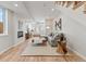 Finished basement featuring hardwood floors, a cozy gray sofa, and a modern fireplace at 1048 Knox Ct, Denver, CO 80204