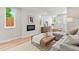 Finished basement with hardwood floors, gray sofa, a fireplace, and natural light from the windows at 1048 Knox Ct, Denver, CO 80204