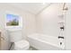 Cozy bathroom with white subway tile and a soaking tub and modern toilet at 1048 Knox Ct, Denver, CO 80204
