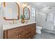 Elegant bathroom with a double sink vanity, marble countertop, and glass-enclosed shower at 1048 Knox Ct, Denver, CO 80204