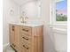 Well-lit bathroom featuring wood vanity, white countertop and modern fixtures at 1048 Knox Ct, Denver, CO 80204