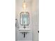 Charming half-bathroom featuring stylish mirror and unique lighting fixture at 1048 Knox Ct, Denver, CO 80204