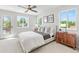 Sun-filled main bedroom features modern decor, plush carpet, and large windows overlooking the neighborhood at 1048 Knox Ct, Denver, CO 80204