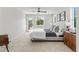 Spacious bedroom with modern ceiling fan, plush carpet, and large windows at 1048 Knox Ct, Denver, CO 80204