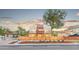 Wide shot of a modern townhome with fenced yard and green space on a city street at 1048 Knox Ct, Denver, CO 80204