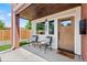 Charming front porch with seating area, wood door, and stylish accents at 1048 Knox Ct, Denver, CO 80204