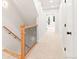 Upstairs hallway features neutral carpet and view to the stairs and backyard door at 1048 Knox Ct, Denver, CO 80204